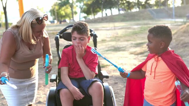 Disabled child with cerebral palsy playing with friends in the park