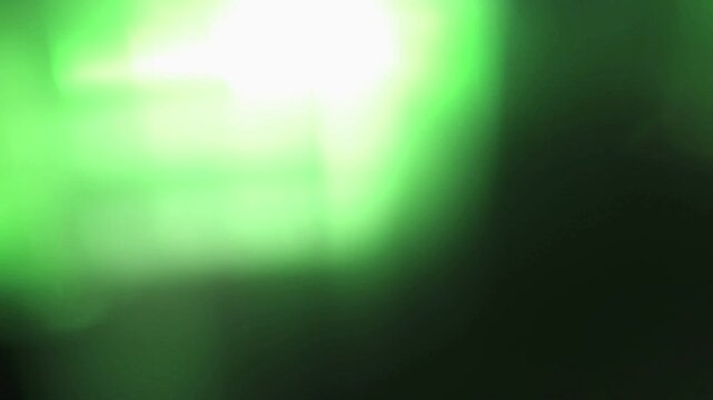 Light leak and bokeh overlay with bright green flares and soft focus, creating a vibrant and dynamic effect. This overlay is perfect for adding cinematic flair to video projects.