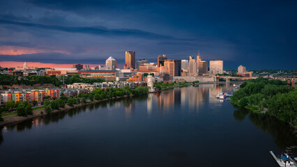 Saint Paul, Minnesota, USA. Aerial cityscape image of downtown St. Paul, Minnesota, USA with reflection of the skyline in Mississippi River at stormy summer sunset.