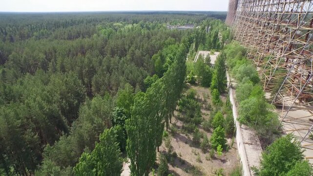 Aerial view of the Duga radar array, a Soviet-era relic, in the Chernobyl Exclusion Zone, Ukraine. Forest reclaims the site.