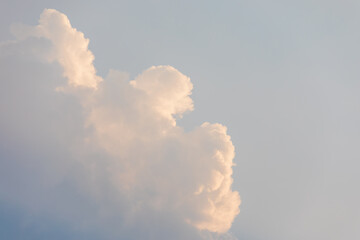 Sunset-Lit Cumulus Cloud in Soft Evening Sky