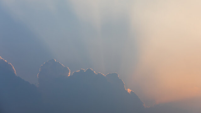 Sunset Sunbeams Behind Large Cumulus Cloud