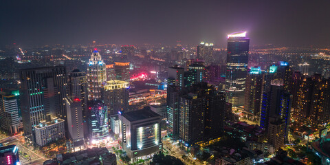 Obraz premium Aerial view of New Taipei City downtown skyline in evening. Panoramic cityscape birds eye view use the drone, shot in Banqiao District, New Taipei, Taiwan.