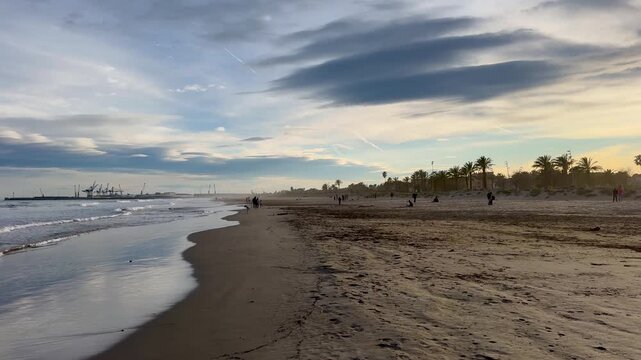 Mediterranean coast on a sunny day in winter. Waves of breeze on a sandy beach. Spain, Castellon de la Plana