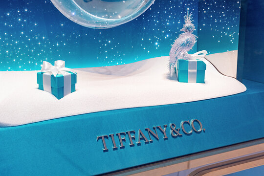 5 December 2025, Abu Dhabi, UAE: Tiffany and Co. Retail window featuring signature blue boxes in a festive winter wonderland setting
