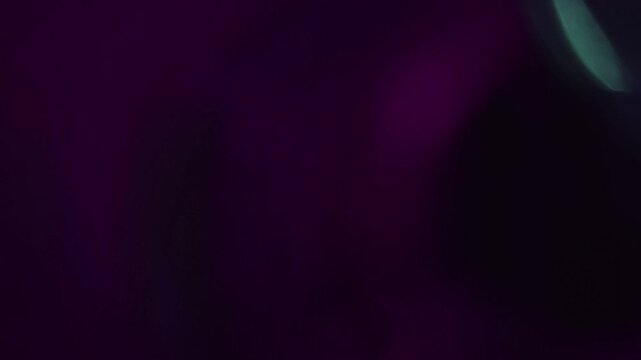 Light leak and bokeh overlay with purple hues, creating a cinematic and dreamy effect. Ideal for adding motion graphics and visual interest to video projects.