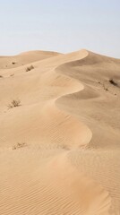 Majestic desert landscape with rolling sand dunes under clear blue sky