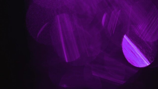 light leak and bokeh overlay of purple circular flares and streaks on a black field. This video is ideal for adding atmospheric effects to projects.