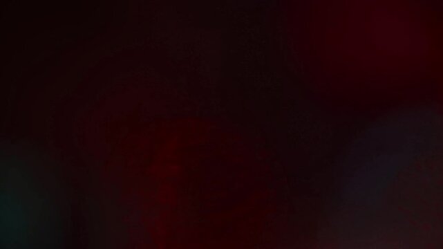 Light leak and bokeh overlay with dark red and teal tones, perfect for adding atmosphere and transitions to your projects. This footage is ideal for creating mood and enhancing visual storytelling.