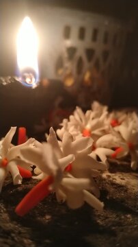 Traditional Oil Lamp with Night Jasmine Flowers Burning in Dark Spiritual Background	