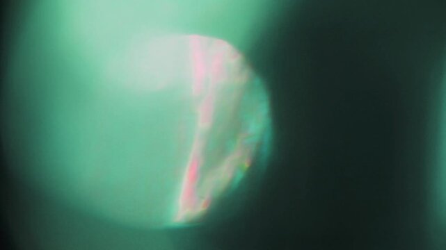 light leak and bokeh overlay with green and pink flares, perfect for adding a dreamy, vintage effect to your projects. Use this as a transition or overlay.