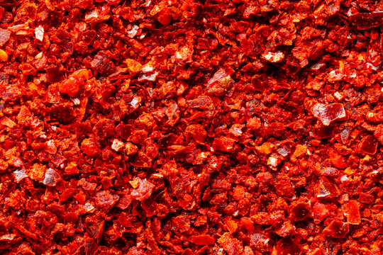 Close-up of gochugaru, Korean chili pepper seedless flakes, background texture. An important ingredient in kimchi and gochujang paste.