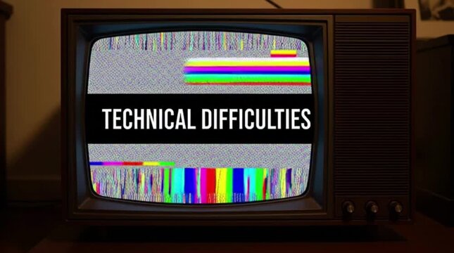 Bright, colorful static interference patterns and a large black banner with white writing signifying technical issues or a broadcast interruption are visible on this vintage television screen
