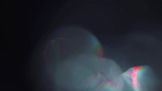 light leak and bokeh overlay with soft glowing iridescent flares and chromatic aberration. This footage is perfect for adding a cinematic touch to your projects.