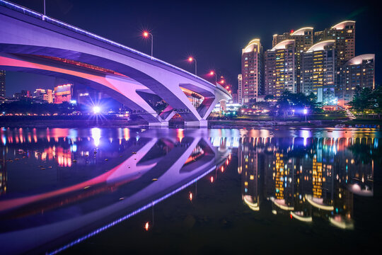Xindian Night View - City skyline and water reflection at night in New Taipei, Taiwan.