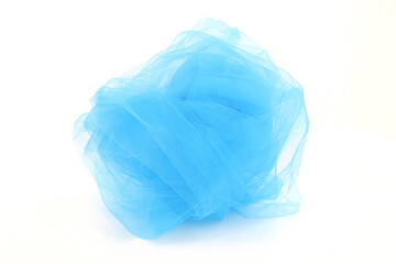 Obraz premium Rolled blue tulle fabric isolated on white background. Delicate mesh netting swirl.