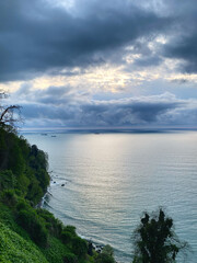 High angle wide view coastal landscape calm sea cloudy sky cargo ships