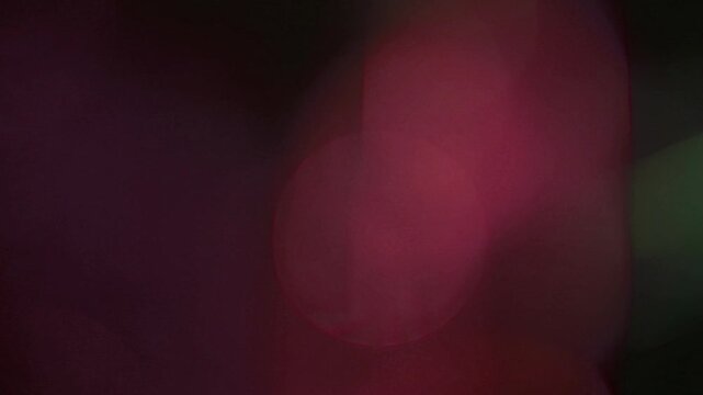 Light leak and bokeh overlay featuring soft, diffused red and green glows. Perfect for adding atmosphere or transition effects to your projects.