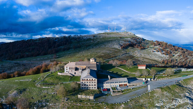 Aerial drone view of the autumn landscape surrounding the beech forest and the Sanctuary of San Miguel de Excelsis in the Sierra de Aralar. Huarte-Araquil, Navarre, Spain, Europe