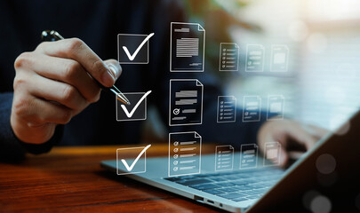 Digital document management and compliance checklist concept with business professional approving files on laptop. Online verification system, audit process, corporate workflow management. © wasan