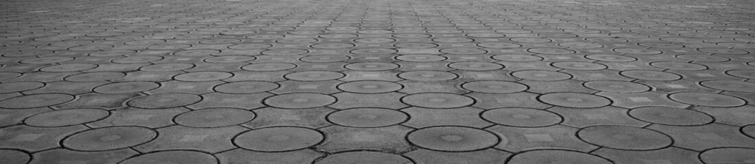 Naklejka premium Geometric gray concrete tile with eco parking cells With round circles texture pattern Top aerial view, paving stones, block tiles made of concrete in the form of connected circles Perspective view