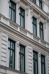 Obraz premium Elegant classical European building facade with decorative windows and balconies 