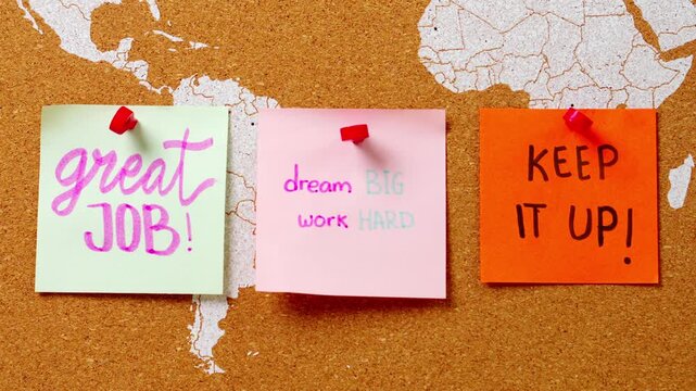 Stop motion of colorful sticky notes with Inspirational messages appearing corkboard world map
