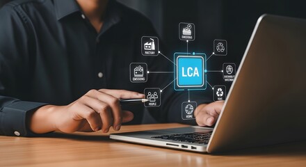 A business professional interacting with a laptop displaying LCA process diagrams