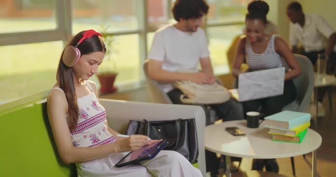 Indian young adult gen z girl use laptop tablet hold look screen do e learning check study work look cam  teen male female man woman talk speak share gossip new ideas enjoy day spend time room place