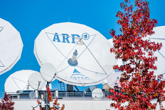 Large white satellite dishes on roof ARD broadcasting building, professional parabolic antennas against sky, telecommunications and media infrastructure, Frankfurt, Germany Information technology