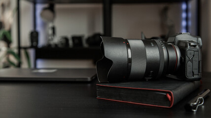 Professional camera and lens resting on a notebook, ready for creative work