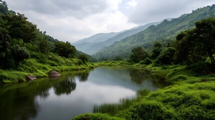 Fototapeta premium Lush green hills surround a tranquil lake with reflections under a cloudy sky