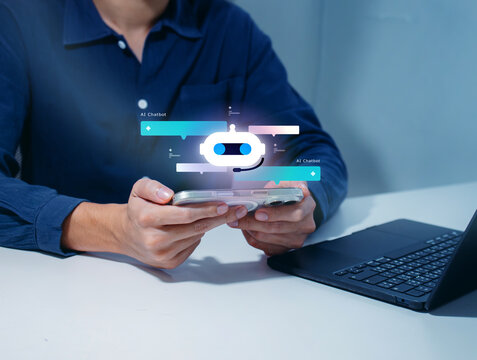 Business professional using AI agent on smartphone to automate daily tasks while working on laptop, managing workflow, scheduling, automating email and customer replies. AI agent workflow concept.