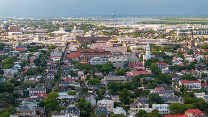 Fototapeta premium Panoramic Aerial view of downtown Charleston, South Carolina skyline and St. Michael's Anglican Church steeple with surrounding neighborhood, historical buildings in lowcountry landscape