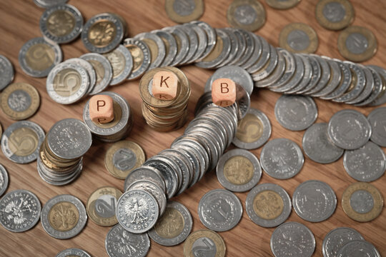Polish zloty coins with PKB letter blocks illustrating GDP, national economy and macroeconomic indicator concept.