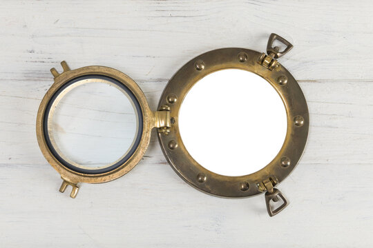 Vintage porthole with transparency in white wooden wall