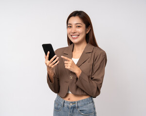 Fototapeta premium Pretty young asian woman using cellphone standing on isolated white background. Happy Excited Beautiful young asian shopping online payment with mobile phone. Playing game on smartphone