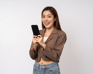 Fototapeta premium Pretty young asian woman using cellphone standing on isolated white background. Happy Excited Beautiful young asian shopping online payment with mobile phone. Playing game on smartphone