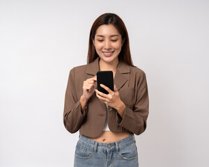 Pretty young asian woman using cellphone standing on isolated white background. Happy Excited Beautiful young asian shopping online payment with mobile phone. Playing game on smartphone