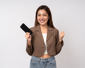 Pretty young asian woman using cellphone standing on isolated white background. Happy Excited...