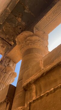 A close-up view of the columns of the ancient Mammisi Chapel in Dendera, Egypt, part of a ceremonial complex dedicated to the goddess Hathor.