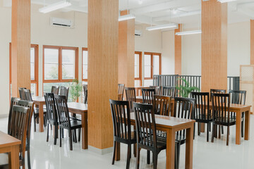 The indoor restaurant atmosphere with pillars, chairs and wooden tables is very traditional and authentic.