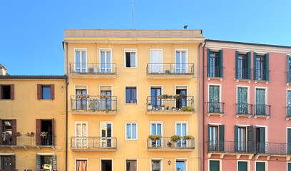 Obraz premium Colorful Apartment Building Facades with Balconies in Italy