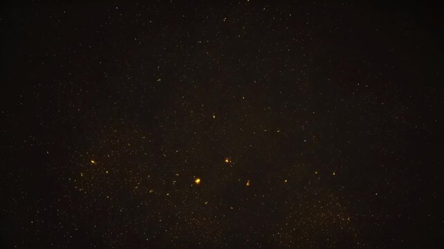 Animation gold glow particle on black background.	
