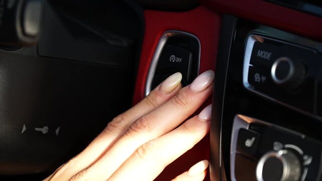 Close-up sequence of hand approaching ignition button in modern vehicle interior, showcasing the action of starting the engine with vibrant textures and sleek design elements
