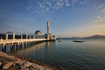 Masjid Al Badr, a beautiful floating mosque at colourful sunrise by calm sea