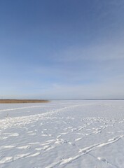 frozen snow-covered large winter lake
