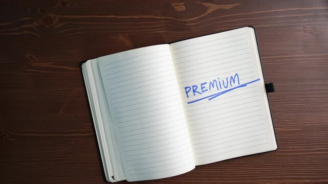 Woman Hand Highlighting 'PREMIUM' in Notebook,  Luxury Brand Value and High End Business Strategy