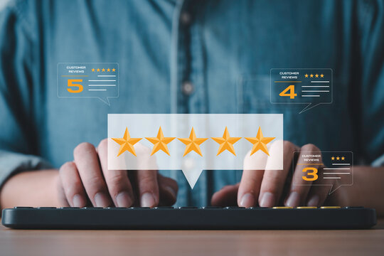 Customer reviews and five star rating feedback concept. Businessman typing on keyboard with online satisfaction survey, digital marketing reputation management and e commerce excellent evaluation.