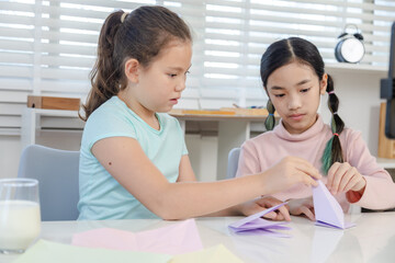 Obraz premium Modern young students online learning content creator, elementary girls explain homework to teacher record paper activity by phone, digital education, creativity vlog, alpha generation study lifestyle